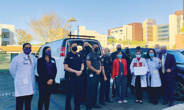 Healthcare workers and police escort COVID vaccines